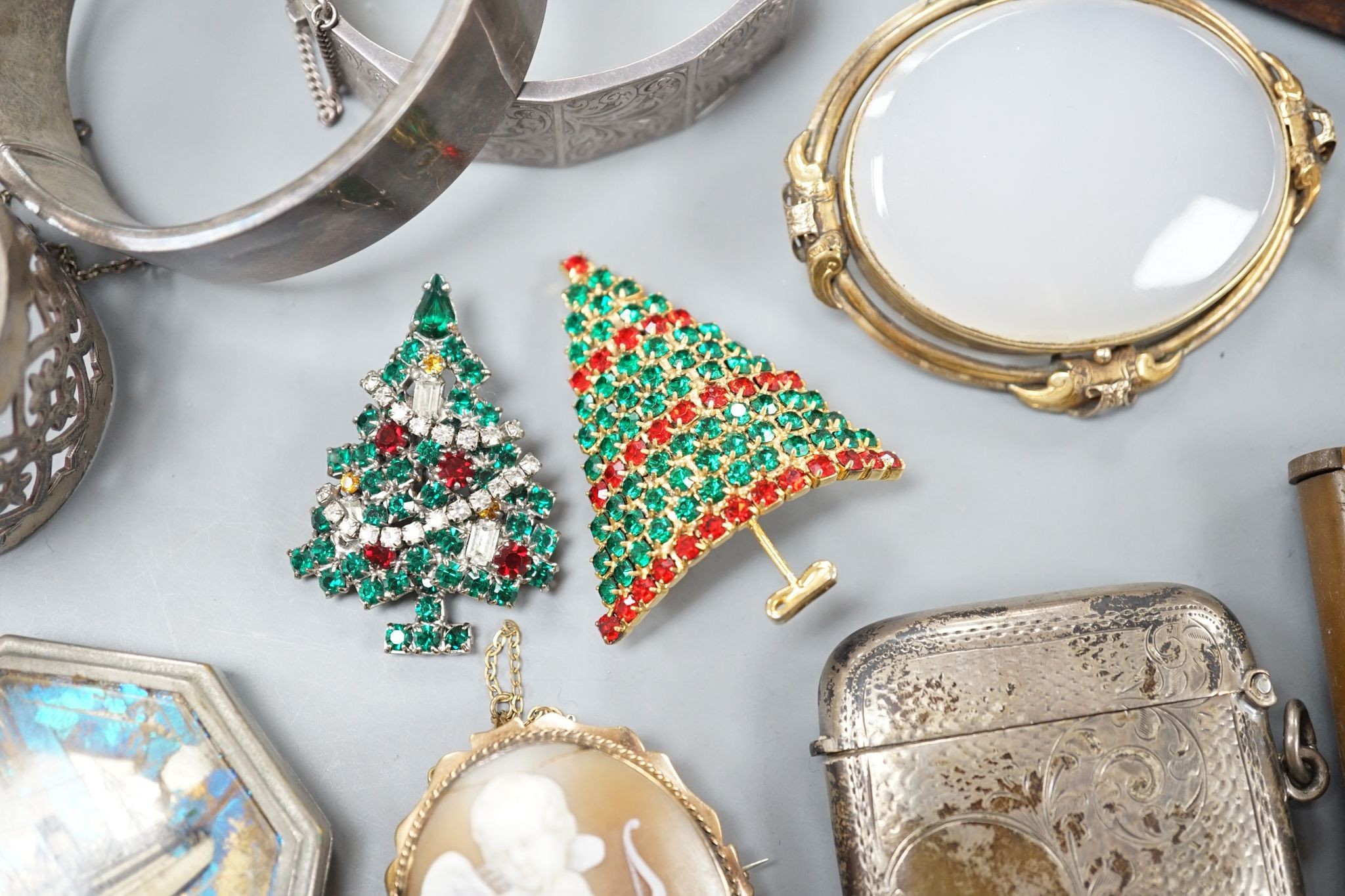 A 9ct mounted oval cameo shell brooch, 47mm, a yellow metal blue paste and diamond cluster set ring, size L, three 9ct rings and other items including silver vesta case, silver bangle and costume jewellery etc.